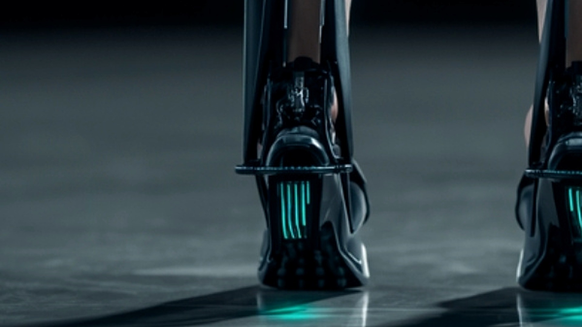 XOWALKER exoskeleton feet with teal LED glow on studio floor